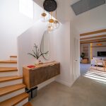 Modern wooden staircase with sleek design and metal railings