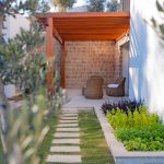 Stone garden path leading through a lush green landscaped garden